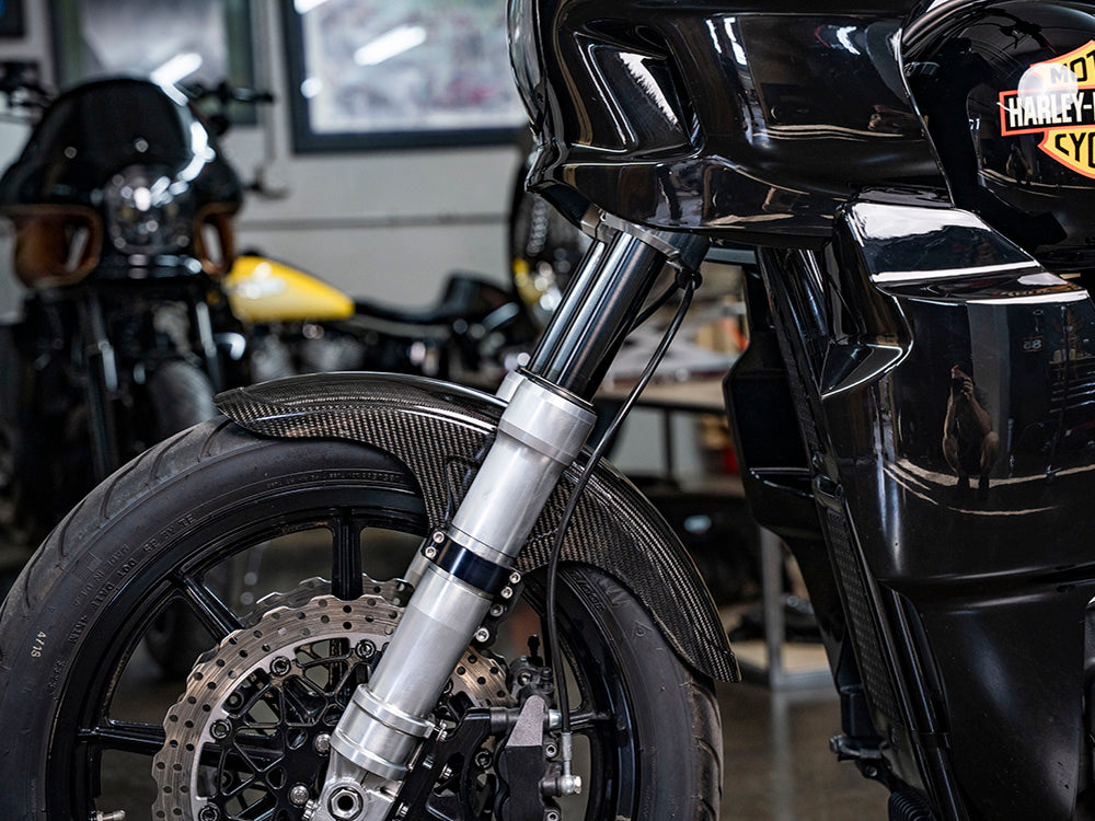 Carbon Front Fender - Gloss Finish. Fits Mid-Glide Dyna 2006-2017, Softail Street Bob 2018up & Standard 2020-2024 with 19in. Front Wheel. Also Fits Softail Low Rider S 2020up & Low Rider ST 2022up with Adapter