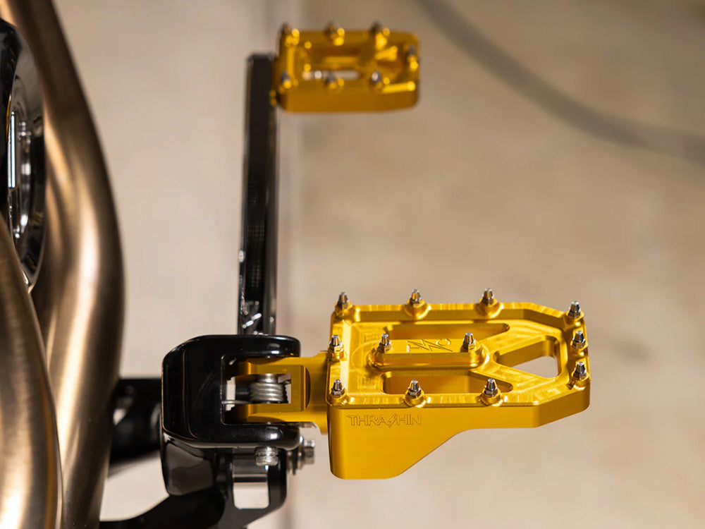 Aggressor Footpegs - Gold. Fits Softail 2018up Front Rider